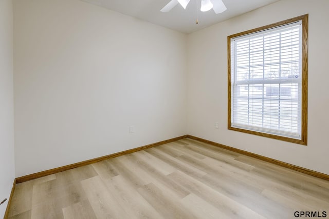 empty room with a ceiling fan, baseboards, and light wood-style flooring