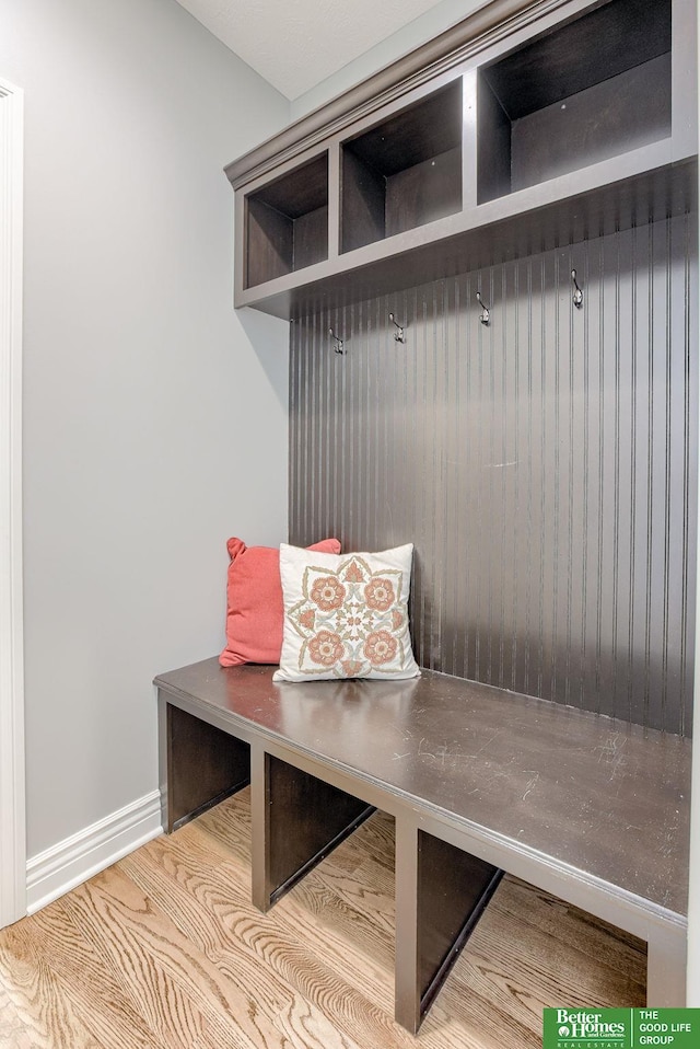 mudroom featuring baseboards and wood finished floors