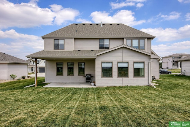 rear view of property with a yard, a patio, and a shingled roof