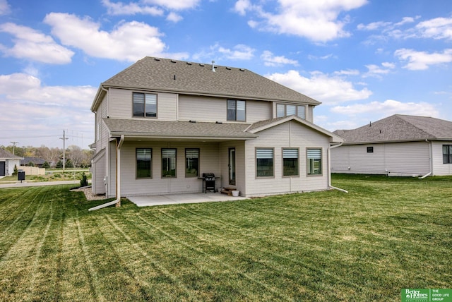 rear view of house featuring a yard, roof with shingles, and a patio area