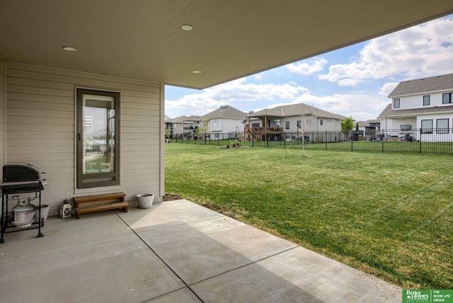 view of yard with entry steps, fence, a residential view, and a patio area