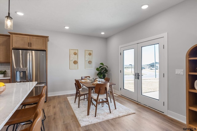 6710 S 207th Ave, Elkhorn, NE 68022 - dining space featuring baseboards, a healthy amount of sunlight, french doors, and light wood-type flooring