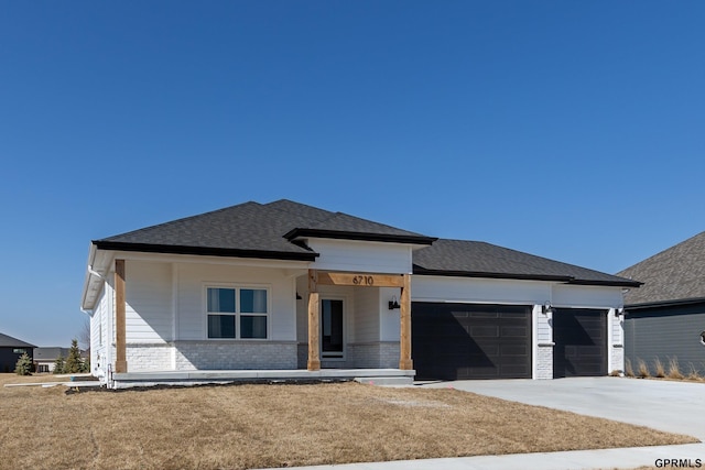 6710 S 207th Ave, Elkhorn, NE 68022 - prairie-style home with a porch, driveway, roof with shingles, brick siding, and an attached garage