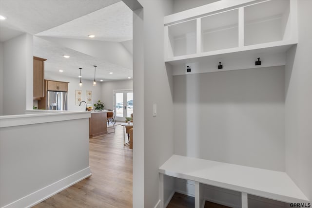 6710 S 207th Ave, Elkhorn, NE 68022 - mudroom with recessed lighting, a textured ceiling, and light wood-type flooring