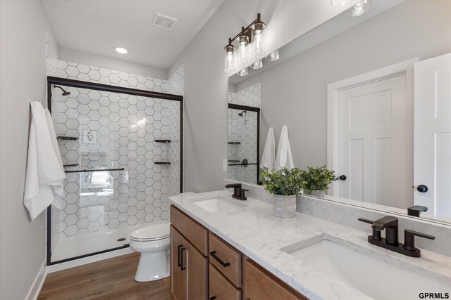 6710 S 207th Ave, Elkhorn, NE 68022 - bathroom featuring a sink, a stall shower, toilet, and visible vents