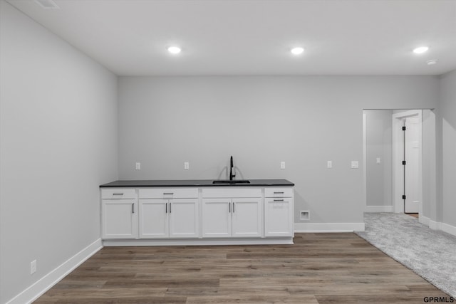 6710 S 207th Ave, Elkhorn, NE 68022 - bar featuring baseboards, a sink, recessed lighting, and light wood-type flooring
