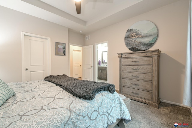 bedroom with a ceiling fan, visible vents, baseboards, connected bathroom, and carpet
