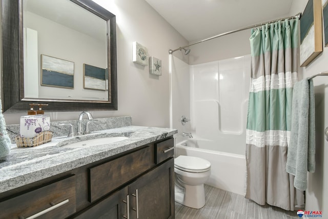 bathroom with vanity, shower / tub combo with curtain, and toilet
