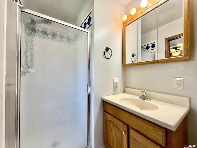 full bathroom featuring vanity and a shower stall