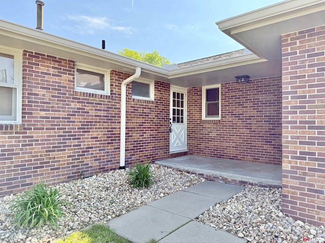 entrance to property with brick siding