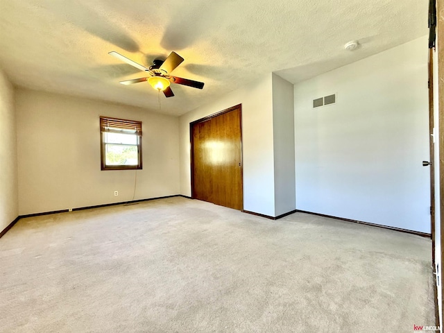 unfurnished bedroom featuring baseboards, visible vents, and a textured ceiling