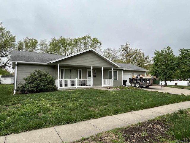 view of front of home with a porch, an attached garage, driveway, a front lawn, and a shingled roof