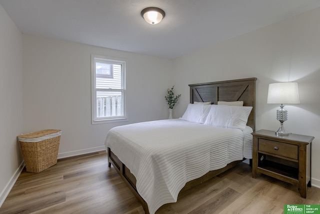 bedroom with light wood-style floors and baseboards