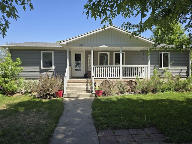 view of front of property with covered porch and a front lawn