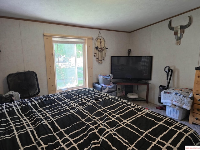 carpeted bedroom with ornamental molding and a textured ceiling