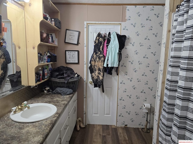 full bathroom with a shower with shower curtain, decorative backsplash, wood finished floors, and vanity