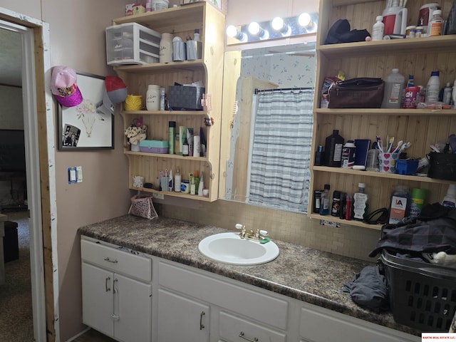 bathroom featuring vanity, decorative backsplash, and a shower with curtain