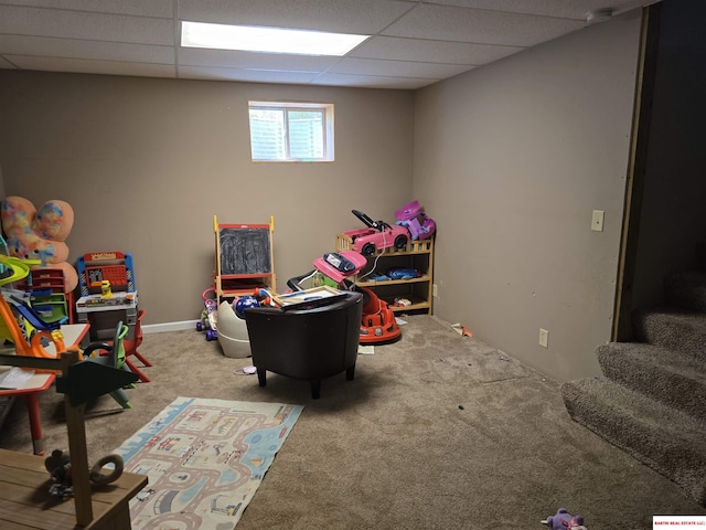 playroom featuring a drop ceiling and carpet