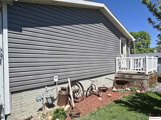 view of property exterior featuring a wooden deck