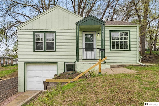 view of front of home with roof with shingles and a garage