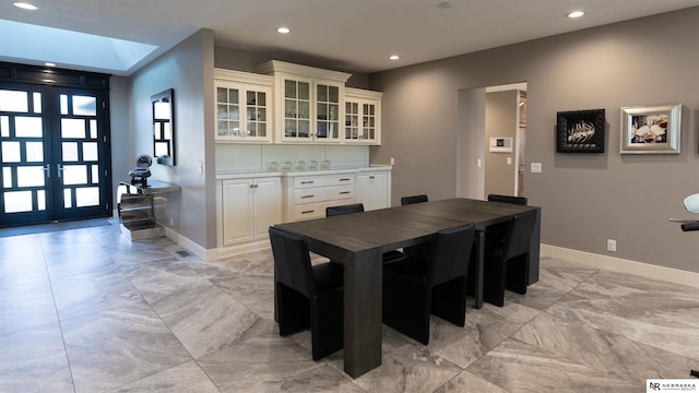 dining room with light marble finish flooring, recessed lighting, baseboards, and french doors