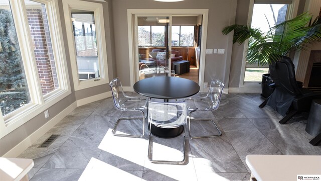 dining space featuring plenty of natural light and baseboards