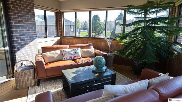 sunroom featuring hardwood / wood-style floors and wood walls