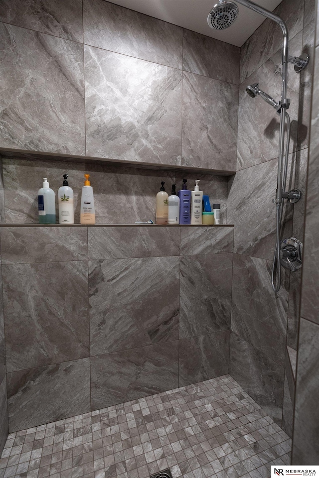 bathroom with a tile shower