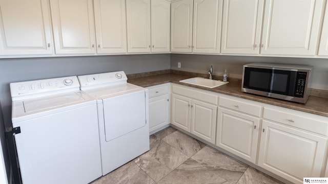 laundry room featuring cabinet space and washing machine and dryer
