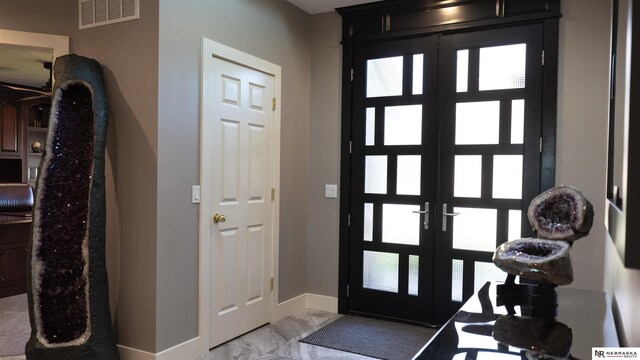 entrance foyer with french doors, baseboards, and light marble finish floors