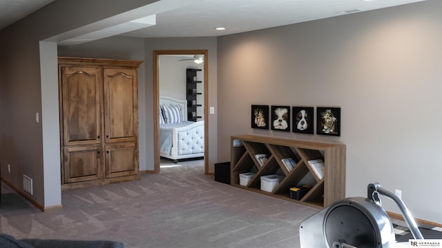 hall featuring baseboards and carpet flooring