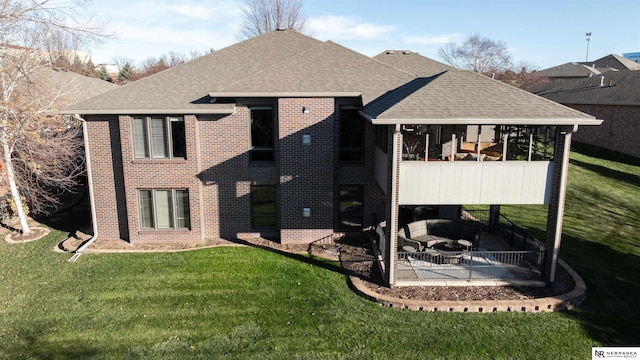 back of house featuring brick siding, a patio, and roof with shingles