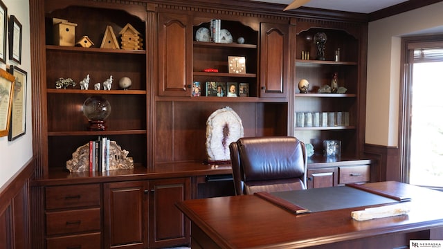office area featuring a wainscoted wall, built in features, and a decorative wall