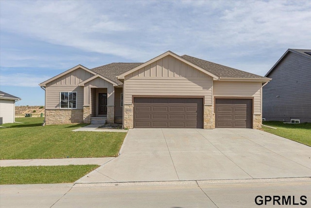 view of front of property with a front yard, an attached garage, stone siding, and board and batten siding