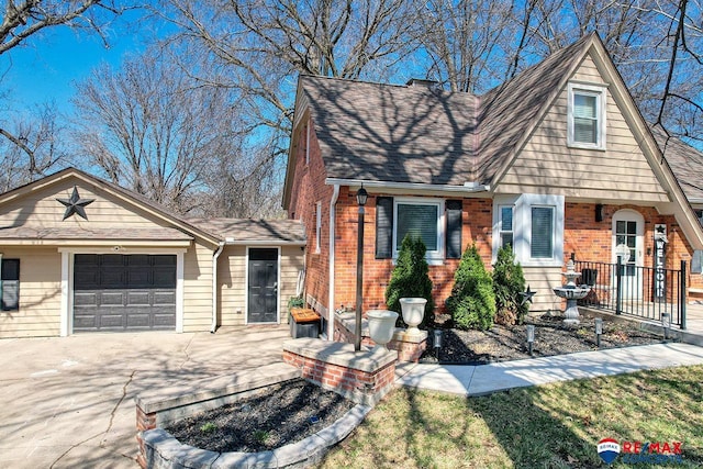 view of front of house with concrete driveway, a shingled roof, brick siding, and an attached garage