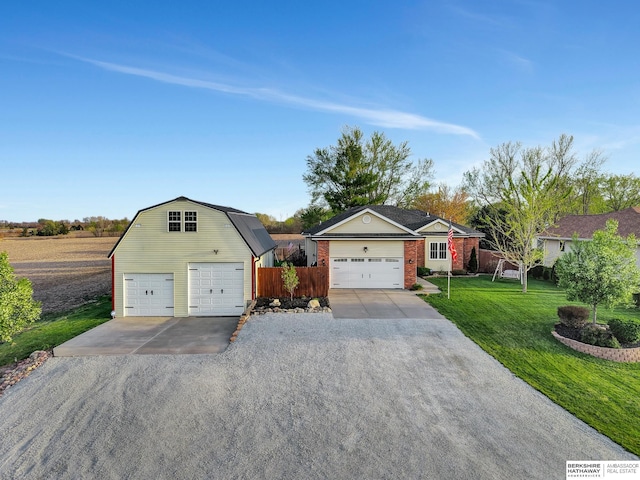 1529 E Apple Rd, Cortland, NE 68331 - view of front of house featuring a gambrel roof, brick siding, fence, a garage, and a front yard