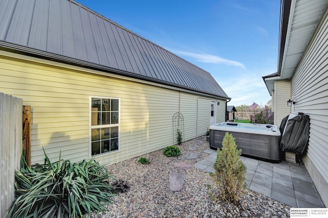 1529 E Apple Rd, Cortland, NE 68331 - view of side of property featuring metal roof, a patio, a hot tub, and fence