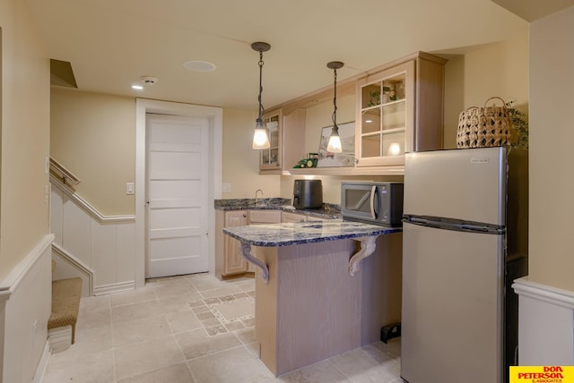 1638 N Nye Ave, Fremont, NE 68025 - kitchen featuring glass insert cabinets, decorative light fixtures, a breakfast bar, a peninsula, and stainless steel appliances
