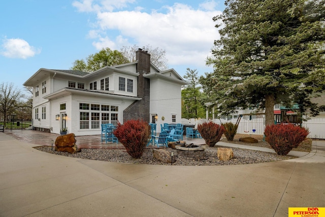 1638 N Nye Ave, Fremont, NE 68025 - rear view of property featuring a patio area, fence, and a chimney