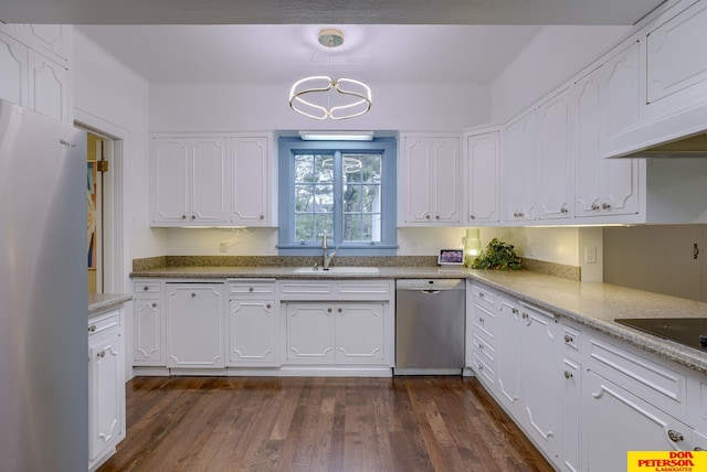 1638 N Nye Ave, Fremont, NE 68025 - kitchen featuring a sink, stainless steel appliances, white cabinets, dark wood finished floors, and decorative light fixtures