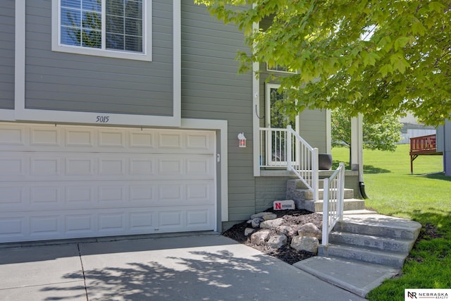 view of side of property featuring a yard, a garage, and driveway