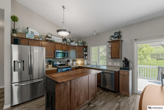 kitchen featuring wood counters, open shelves, dark wood finished floors, vaulted ceiling, and appliances with stainless steel finishes