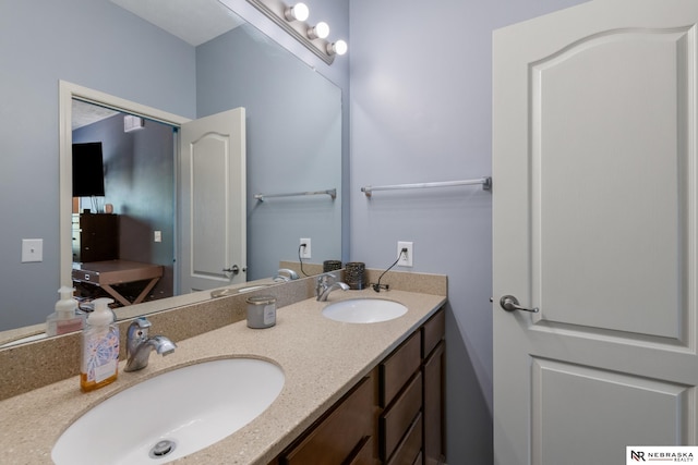 bathroom featuring a sink and double vanity