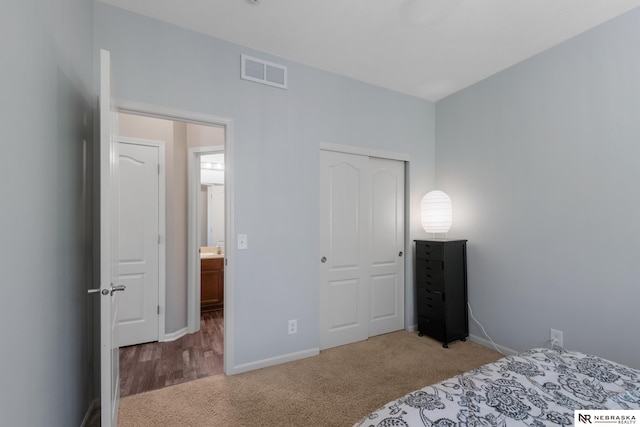 bedroom with baseboards, a closet, visible vents, and carpet floors