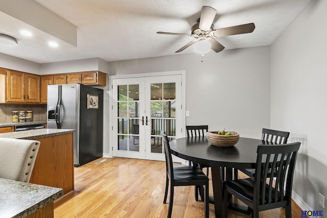 dining space featuring french doors, a ceiling fan, baseboards, light wood-style floors, and recessed lighting