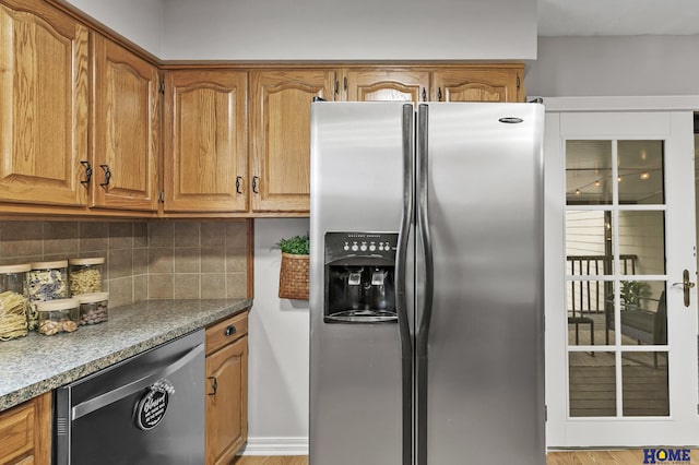 kitchen with dishwasher, decorative backsplash, brown cabinets, and stainless steel refrigerator with ice dispenser