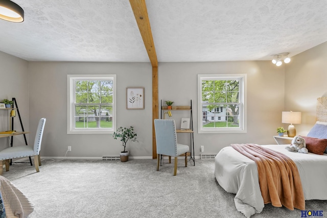 carpeted bedroom featuring a textured ceiling, baseboards, visible vents, and multiple windows
