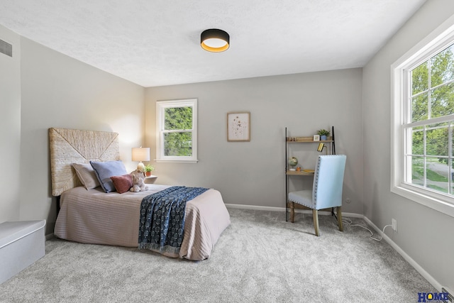 bedroom with baseboards, carpet flooring, and visible vents