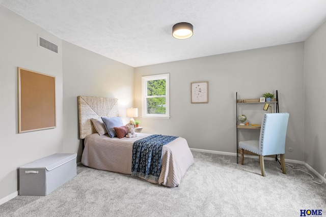carpeted bedroom featuring visible vents and baseboards