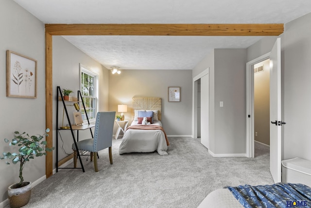 bedroom featuring baseboards, beam ceiling, and carpet floors